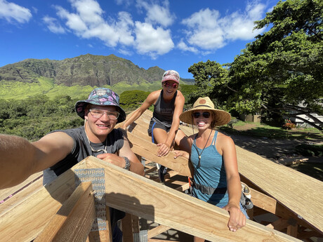 Student missionaries work on roof construction